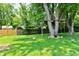 Large backyard featuring mature trees, a playset and free-range chickens at 2700 Yellowwood Ct, Columbus, IN 47203