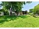 Expansive backyard featuring mature trees, playset, trampoline and a screened-in porch at 2700 Yellowwood Ct, Columbus, IN 47203