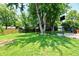 Large backyard featuring mature trees, a playset and a basketball hoop at 2700 Yellowwood Ct, Columbus, IN 47203