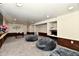 Finished basement featuring brick and white walls, grey carpet, and large beanbag chairs at 2700 Yellowwood Ct, Columbus, IN 47203