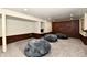 Finished basement featuring brick and white walls, grey carpet, and large beanbag chairs at 2700 Yellowwood Ct, Columbus, IN 47203