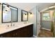Bathroom with dual sinks, dark wood cabinetry, and large mirrors, complete with modern fixtures at 2700 Yellowwood Ct, Columbus, IN 47203