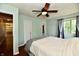 Bright bedroom featuring hardwood floors, a ceiling fan, and a large window at 2700 Yellowwood Ct, Columbus, IN 47203