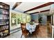 Cozy dining area with large window, wood table, and built-in bookshelf at 2700 Yellowwood Ct, Columbus, IN 47203