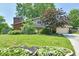 Charming home with a brick chimney and beautiful landscaping, offering curb appeal at 2700 Yellowwood Ct, Columbus, IN 47203