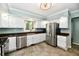 Bright kitchen with white cabinets, stainless steel refrigerator, sink and dishwasher at 2700 Yellowwood Ct, Columbus, IN 47203