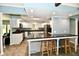 Open kitchen layout with island, white cabinets, and stainless steel appliances at 2700 Yellowwood Ct, Columbus, IN 47203