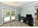 Bright office space with desk setup and sliding doors to the outdoor patio space at 2700 Yellowwood Ct, Columbus, IN 47203