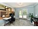 Bright office space with a sliding glass door and a workstation at 2700 Yellowwood Ct, Columbus, IN 47203