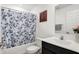 Bathroom featuring a bathtub with shower, blue patterned curtain, and vanity with a mirror at 2795 Lanai Ln, Greenwood, IN 46143