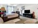 Bedroom with a large bed, exercise equipment, and a TV stand, creating a modern and functional space at 2795 Lanai Ln, Greenwood, IN 46143