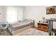 Bedroom with a bed, bedside table, carpeted floors, and a window dressed with curtains, creating a cozy atmosphere at 2795 Lanai Ln, Greenwood, IN 46143