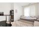 Bedroom with a bed, bedside table, carpeted floors, and a window dressed with curtains, creating a peaceful atmosphere at 2795 Lanai Ln, Greenwood, IN 46143
