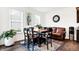 Dining room features a wooden table and chairs, modern decor, and two windows with natural light at 2795 Lanai Ln, Greenwood, IN 46143