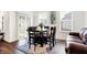 Cozy dining room featuring a wooden table with chairs, a sliding door to the backyard, and modern decor at 2795 Lanai Ln, Greenwood, IN 46143