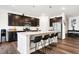 A kitchen featuring stainless appliances, a kitchen island with barstool seating and dark wood cabinetry at 2795 Lanai Ln, Greenwood, IN 46143