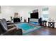 Modern living area with hardwood floors, reclining sofas, and an entertainment center at 2795 Lanai Ln, Greenwood, IN 46143