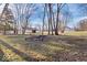 Spacious backyard with mature trees and a designated fire pit area at 300 Indiana Ave, Pendleton, IN 46064