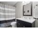Bathroom with striped shower curtain, modern vanity, and a large mirror offering a clean and contemporary look at 300 Indiana Ave, Pendleton, IN 46064
