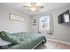 Comfortable bedroom with ceiling fan, TV, and natural light from the window at 300 Indiana Ave, Pendleton, IN 46064