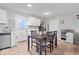 Bright eat-in kitchen with white cabinetry, hardwood floors, stainless steel appliances, and lots of natural light at 300 Indiana Ave, Pendleton, IN 46064