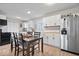 Eat-in kitchen with stainless steel appliances, white cabinets, and a stylish dining table for Gathering meals at 300 Indiana Ave, Pendleton, IN 46064