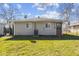 Spacious backyard with a well-maintained lawn, mature trees, and a fenced perimeter at 3109 Welch Dr, Indianapolis, IN 46224