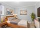 Cozy bedroom with natural wood furniture, neutral color palette, and decorative artwork at 3109 Welch Dr, Indianapolis, IN 46224