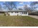 Charming single-story home featuring gray siding, white trim, and a well-maintained lawn on a sunny day at 3109 Welch Dr, Indianapolis, IN 46224