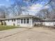 View of a one-story home with a detached garage, showcasing a concrete driveway and tidy landscaping at 3109 Welch Dr, Indianapolis, IN 46224