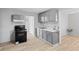 Functional kitchen with modern appliances, gray cabinets, and hardwood floors, perfect for cooking and entertaining at 3109 Welch Dr, Indianapolis, IN 46224
