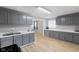 Well-maintained kitchen featuring gray cabinets, modern appliances, and hardwood floors with views to the dining room at 3109 Welch Dr, Indianapolis, IN 46224