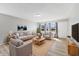Bright living room with hardwood floors, stylish furniture, and plenty of natural light from large windows at 3109 Welch Dr, Indianapolis, IN 46224