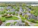 Aerial view of a neighborhood with mature trees and winding streets by the lake at 3539 Clearwater Cir, Indianapolis, IN 46240