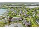Aerial view showcases a lakeside community with lush landscaping, mature trees, and waterways at 3539 Clearwater Cir, Indianapolis, IN 46240