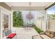 Relaxing covered porch with outdoor seating overlooking a landscaped backyard with mature trees at 3539 Clearwater Cir, Indianapolis, IN 46240