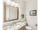 Bathroom with a modern vanity and granite countertops, complemented by a large mirror at 3539 Clearwater Cir, Indianapolis, IN 46240