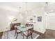 Dining room with hardwood floors adjacent to the kitchen with a breakfast bar and pendant lights at 3539 Clearwater Cir, Indianapolis, IN 46240