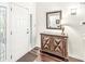 Inviting home foyer features hardwood floors, elegant cabinet, mirror and decorative light fixture at 3539 Clearwater Cir, Indianapolis, IN 46240