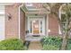 Close-up of home's front entrance with glass door, brick accents, and decorative landscaping at 3539 Clearwater Cir, Indianapolis, IN 46240