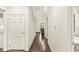 Hallway with hardwood floors and multiple doors, leading to different areas of the house at 3539 Clearwater Cir, Indianapolis, IN 46240