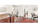 Hallway view with hardwood floors leading to a staircase and open kitchen with stainless steel appliances at 3539 Clearwater Cir, Indianapolis, IN 46240