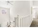Bright hallway featuring white trim, neutral walls, and natural light from the window at 3539 Clearwater Cir, Indianapolis, IN 46240
