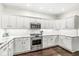 Well-lit kitchen showcasing white cabinetry, stainless steel appliances, and granite countertops at 3539 Clearwater Cir, Indianapolis, IN 46240