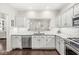 Bright kitchen with white cabinets, stainless appliances, brick backsplash, and granite counters at 3539 Clearwater Cir, Indianapolis, IN 46240