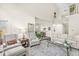 Bright living room with neutral tones, elegant furnishings, and an open floor plan leading to the kitchen at 3539 Clearwater Cir, Indianapolis, IN 46240
