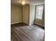 Cozy bedroom features gray wood-look flooring, fresh paint, and a closet at 354 Bloomingdale Rd, Montezuma, IN 47862