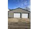 View of a large two car garage with metal siding and two white doors at 354 Bloomingdale Rd, Montezuma, IN 47862