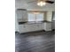 Spacious kitchen with white cabinets, a ceiling fan, neutral countertops, and vinyl flooring at 354 Bloomingdale Rd, Montezuma, IN 47862
