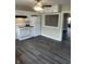 Bright kitchen features white cabinets, modern appliances, and vinyl flooring at 354 Bloomingdale Rd, Montezuma, IN 47862